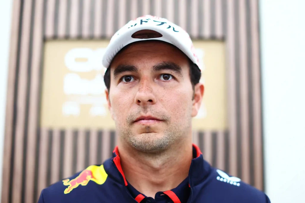 SUZUKA, JAPAN - APRIL 04: Sergio Perez of Mexico and Oracle Red Bull Racing looks on in the Paddock during previews ahead of the F1 Grand Prix of Japan at Suzuka International Racing Course on April 04, 2024 in Suzuka, Japan. (Photo by Mark Thompson/Getty Images)